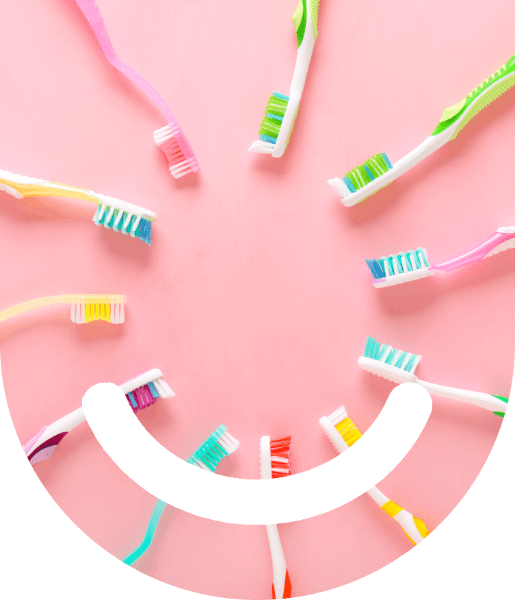 A group of toothbrushes arranged in the shape of a smile.